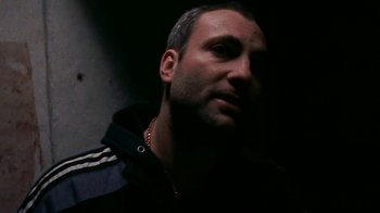 Movie still from “Pusher” (1996), directed by Nicolas Winding Refn – A person wearing a jacket; Close Up shot, Low angle