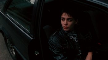 Movie still from “Pusher” (1996), directed by Nicolas Winding Refn – A woman sitting in a car looking out the window; Close Up shot, High angle