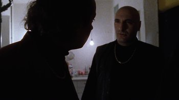 Movie still from “Pusher” (1996), directed by Nicolas Winding Refn – A man and a woman are looking at each other; Medium shot, Over the shoulder angle