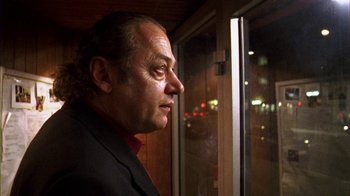 Movie still from “Pusher III” (2005), directed by Nicolas Winding Refn – A person looking out of a window; Close Up shot, Low angle