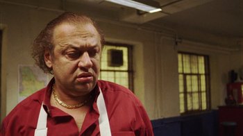 Movie still from “Pusher III” (2005), directed by Nicolas Winding Refn – A person wearing a red shirt; Close Up shot, Low angle