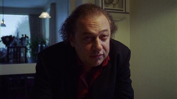 Movie still from “Pusher III” (2005), directed by Nicolas Winding Refn – A person wearing a suit and tie; Close Up shot, Low angle