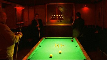 Movie still from “Pusher II” (2004), directed by Nicolas Winding Refn – Two men are playing a game of billiards; Wide shot, High angle