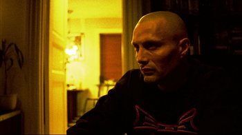 Movie still from “Pusher II” (2004), directed by Nicolas Winding Refn – A man with bald head sitting in front of a mirror; Close Up shot, Low angle