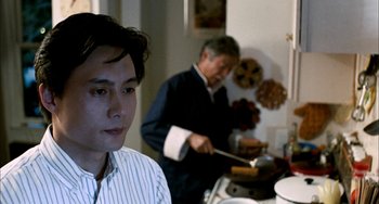 Movie still from “Pushing Hands” (1991), directed by Ang Lee – Two men cooking food in a kitchen; Close Up shot, Over the shoulder angle