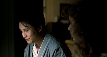 Movie still from “Pushing Hands” (1991), directed by Ang Lee – A man and a woman sitting next to each other in a room; Close Up shot, Over the shoulder angle