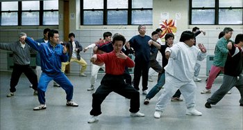Movie still from “Pushing Hands” (1991), directed by Ang Lee – A group of people are doing different kinds of martial arts; Wide shot, High angle