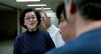 Movie still from “Pushing Hands” (1991), directed by Ang Lee – An older woman and a younger man in a room; Medium shot, Over the shoulder angle