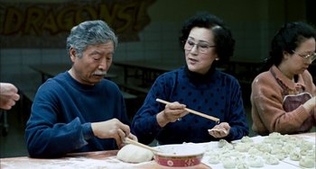Movie still from “Pushing Hands” (1991), directed by Ang Lee – A man and a woman making dumplings at a table; Medium shot, High angle