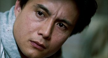 Movie still from “Pushing Hands” (1991), directed by Ang Lee – A man's face with a serious look on his face; Extreme Close Up shot, Low angle