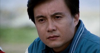 Movie still from “Pushing Hands” (1991), directed by Ang Lee – A person wearing a blue shirt; Close Up shot, Low angle