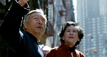 Movie still from “Pushing Hands” (1991), directed by Ang Lee – An older man standing next to an older woman; Close Up shot, Low angle