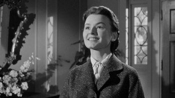 Movie still from “Queen Bee” (1955), directed by Ranald MacDougall – An old photo of a woman smiling for the camera; Close Up shot, Low angle