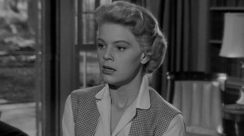 Movie still from “Queen Bee” (1955), directed by Ranald MacDougall – A black - and - white photo of a woman in a checkered vest; Close Up shot, Low angle