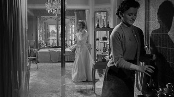 Movie still from “Queen Bee” (1955), directed by Ranald MacDougall – Two women are in a room with a bed and a dresser in the background; Medium shot, Low angle