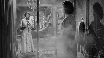 Movie still from “Queen Bee” (1955), directed by Ranald MacDougall – Two women are standing in front of each other in a room; Medium shot, Low angle