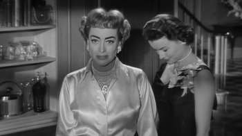 Movie still from “Queen Bee” (1955), directed by Ranald MacDougall – A woman in a satin shirt and a woman in a satin dress; Close Up shot, Over the shoulder angle