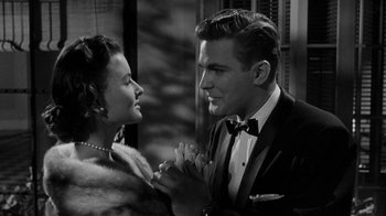 Movie still from “Queen Bee” (1955), directed by Ranald MacDougall – A man and a woman holding hands in front of each other; Close Up shot, Over the shoulder angle