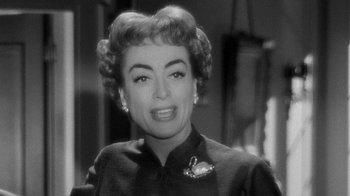 Movie still from “Queen Bee” (1955), directed by Ranald MacDougall – An old photo of an older woman in a black dress; Close Up shot, Over the shoulder angle