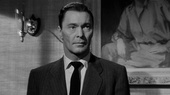 Movie still from “Queen Bee” (1955), directed by Ranald MacDougall – Black and white photograph of a man wearing a suit and tie; Close Up shot, Low angle