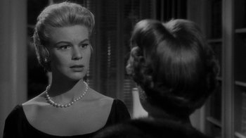 Movie still from “Queen Bee” (1955), directed by Ranald MacDougall – A black - and - white photo of a woman looking at another woman; Close Up shot, Over the shoulder angle