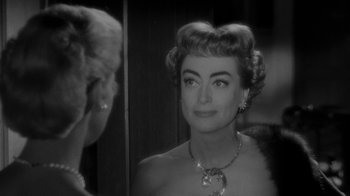 Movie still from “Queen Bee” (1955), directed by Ranald MacDougall – An older woman looking at herself in the mirror; Close Up shot, Over the shoulder angle