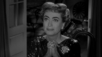 Movie still from “Queen Bee” (1955), directed by Ranald MacDougall – An old photo of an older woman in a black dress; Close Up shot, Over the shoulder angle