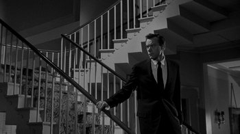 Movie still from “Queen Bee” (1955), directed by Ranald MacDougall – A black and white photo of a man in a suit and tie; Medium shot, Low angle