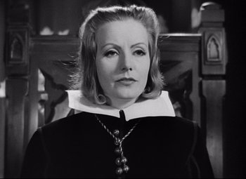 Movie still from “Queen Christina” (1933), directed by Rouben Mamoulian – An old photo of a woman in a black dress; Close Up shot, Over the shoulder angle