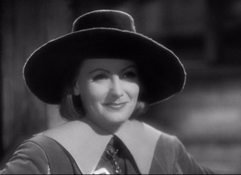 Movie still from “Queen Christina” (1933), directed by Rouben Mamoulian – A black and white photo of a woman wearing a hat; Close Up shot, High angle