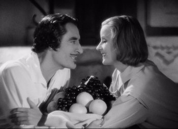 Movie still from “Queen Christina” (1933), directed by Rouben Mamoulian – A man and a woman are smiling at each other; Medium shot, High angle