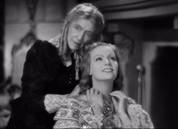 Movie still from “Queen Christina” (1933), directed by Rouben Mamoulian – An older woman is helping a younger woman with her hair; Close Up shot, High angle