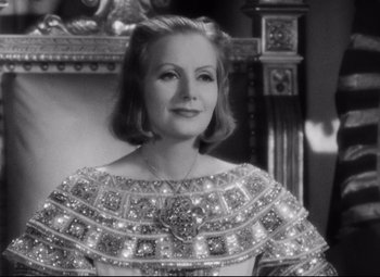 Movie still from “Queen Christina” (1933), directed by Rouben Mamoulian – An old photo of a woman wearing a dress; Close Up shot, Over the shoulder angle