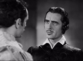Movie still from “Queen Christina” (1933), directed by Rouben Mamoulian – A man with a mustache is looking at another man with a mustache; Close Up shot, Over the shoulder angle