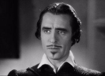 Movie still from “Queen Christina” (1933), directed by Rouben Mamoulian – Black and white photograph of a man with a mustache; Close Up shot, Low angle
