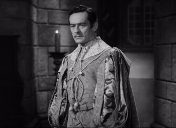 Movie still from “Queen Christina” (1933), directed by Rouben Mamoulian – A black and white photo of a man in a medieval outfit; Medium shot, High angle