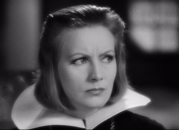 Movie still from “Queen Christina” (1933), directed by Rouben Mamoulian – An old photo of a woman in a black and white photo; Close Up shot, Over the shoulder angle