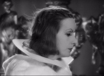 Movie still from “Queen Christina” (1933), directed by Rouben Mamoulian – A black - and - white photo of a woman in a white dress; Close Up shot, High angle