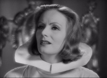 Movie still from “Queen Christina” (1933), directed by Rouben Mamoulian – A woman wearing a neck brace in a black and white photo; Close Up shot, Low angle