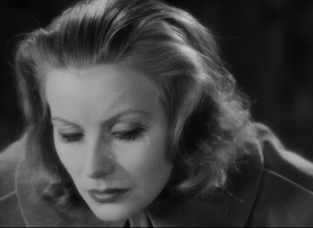 Movie still from “Queen Christina” (1933), directed by Rouben Mamoulian – An old photo of a woman with a sad look on her face; Close Up shot, High angle