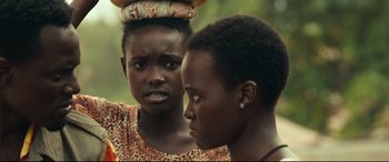 Movie still from “Queen of Katwe” (2016), directed by Mira Nair – Two young women standing next to each other; Close Up shot, Over the shoulder angle