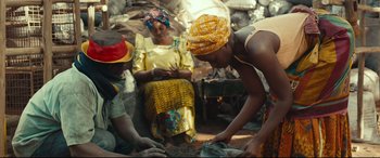 Movie still from “Queen of Katwe” (2016), directed by Mira Nair – A group of people standing next to each other in a room; Medium shot, Low angle