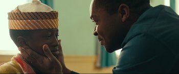 Movie still from “Queen of Katwe” (2016), directed by Mira Nair – A man and a woman looking at one another; Close Up shot, Over the shoulder angle