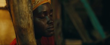 Movie still from “Queen of Katwe” (2016), directed by Mira Nair – A person wearing a headdress; Close Up shot, High angle