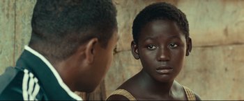 Movie still from “Queen of Katwe” (2016), directed by Mira Nair – Two young men are looking at each other; Close Up shot, Over the shoulder angle