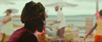 Movie still from “Queen of Katwe” (2016), directed by Mira Nair – A person wearing a head scarf; Close Up shot, Over the shoulder angle