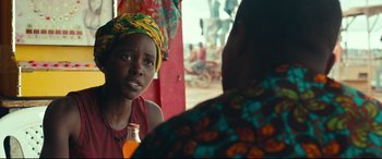 Movie still from “Queen of Katwe” (2016), directed by Mira Nair – A woman in a head scarf is talking to another woman; Close Up shot, Over the shoulder angle