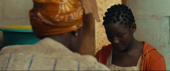 Movie still from “Queen of Katwe” (2016), directed by Mira Nair – A young girl is looking down at a woman; Close Up shot, Over the shoulder angle
