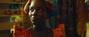 Movie still from “Queen of Katwe” (2016), directed by Mira Nair – A person wearing a headscarf; Close Up shot, Low angle