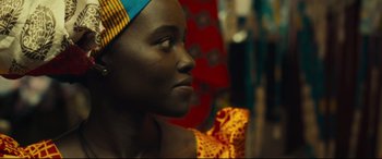 Movie still from “Queen of Katwe” (2016), directed by Mira Nair – A person wearing a headscarf; Close Up shot, Over the shoulder angle